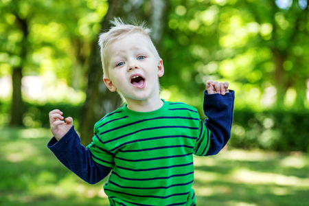 Emotional little boy in the park. 2-3 years. Kindergartens. The concept is childhood and family.の写真素材