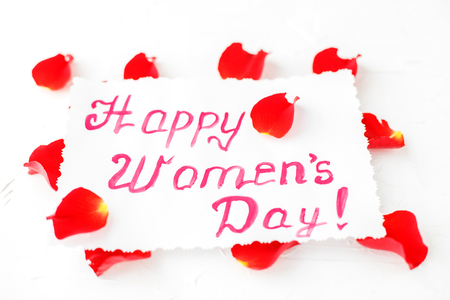 Background with greetings and petals of roses. Concept of Happy Women's Day.の写真素材