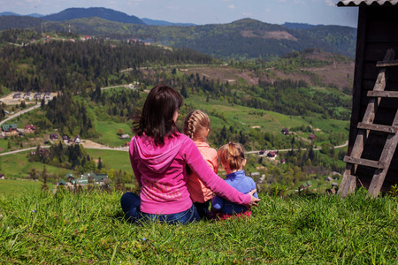 Mother and two children in the mountains. The concept of travel and lifestyle.の写真素材