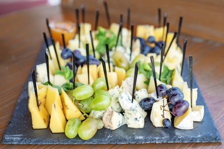 Italian cheeses, grapes, honey and mint. Concept of eating, snacの写真素材