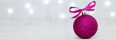White background. pink ball. Banner for the site. The concept of Christmas and New Year.