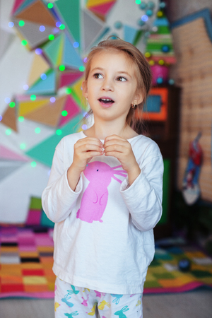 Little girl in pajamas singing. The concept of Christmas.の写真素材