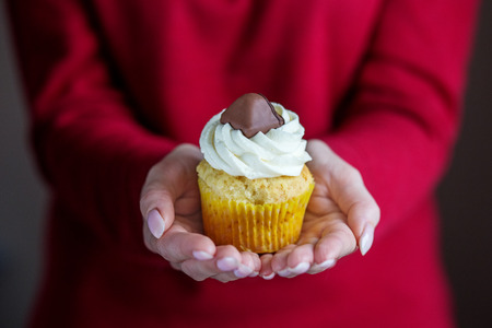Cupcake with vanilla cream and candy. Concept for food, desserts, bakery, celebration, birthdayの写真素材