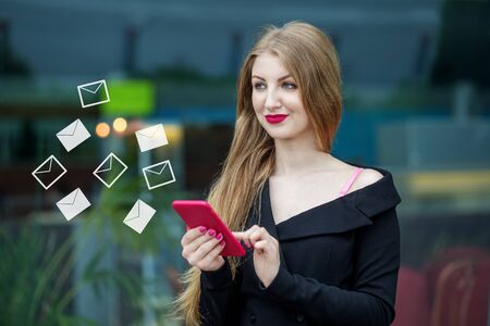 Beautiful young woman writes online messages. The concept of the Internet, technology, social...