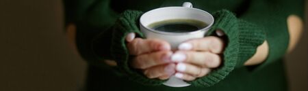 A cup of hot coffee in the hands. Concept drinks, lifestyle, work, backgroundの写真素材