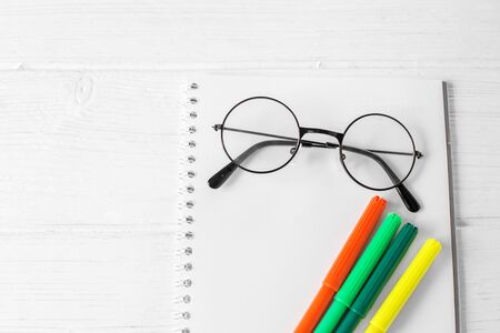 Color markers, notebook and glasses. The concept of school, creativity, childhood and work.の写真素材