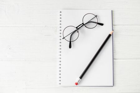 Blank notebook, pencil and glasses. The concept of school, creativity, childhood and work.の写真素材