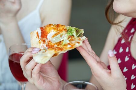 A delicious slice of pizza. Concept of food, fast food, pizzeria.