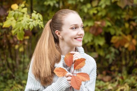 Beautiful girl is smiling. Thick hair. The concept of lifestyle, autumn and relax.