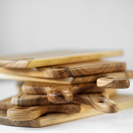 A lot of wooden kitchen boards. Place for text. The concept of housekeeping and cooking.