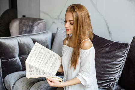 A girl holds sheets of music, a romantic actress with long hair.の写真素材