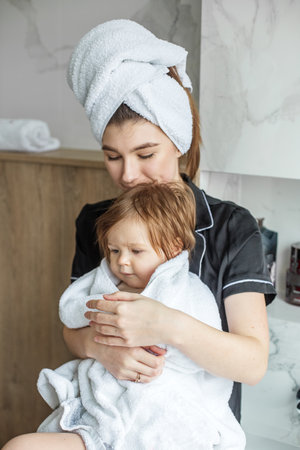 white towels. Cozy house. family time. Daily hygiene procedures. mother's love for baby.の写真素材
