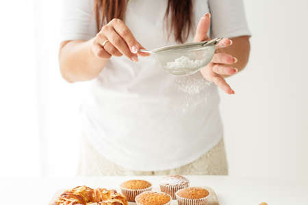 home chef. An amateur recipe for cupcakes and desserts. Housewife cooks in kitchen.の写真素材