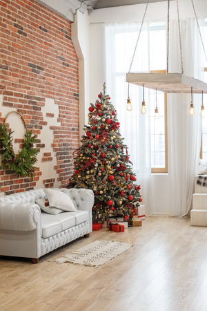 Interior of living room in loft is decorated with Christmas tree. Concept of Happy Christmas, New Year, holiday, background.の写真素材