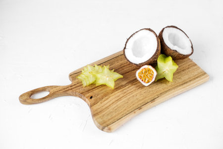 coconut, passion fruit and carambola on a wooden board