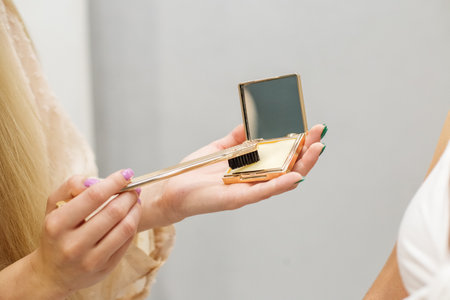 woman applying makeup brush in her hands