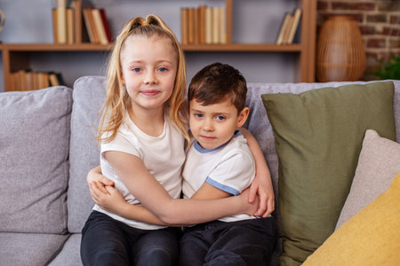 Happy siblings hugging feeling love and connection. Two children have good relationship. Family concept.の写真素材