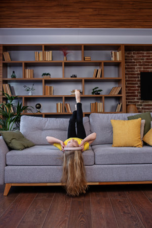 Having fun. Top view. Happy child listens to music or audiobook. Little school kid wearing headphones. Music makes my dayの写真素材