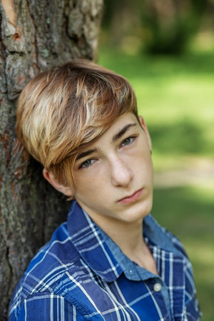 Close-up portrait of a teenager boy outdoors. Gen Z. Identity development.の写真素材