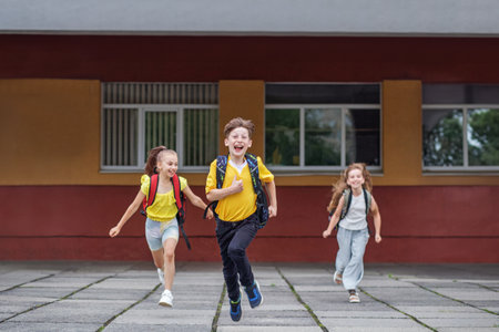 Back to school. Beginning of school lessons. Concept of school, study, education, friendship, childhood. Schoolchildren runの写真素材