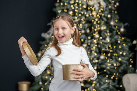 Child opening gift box. Concept New Year, Merry Christmas, holiday, vacation, winter, childhood.の写真素材