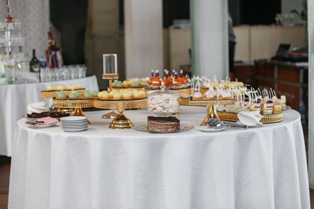 Candy bar. Table with sweets, candies, and dessert. Wedding event.