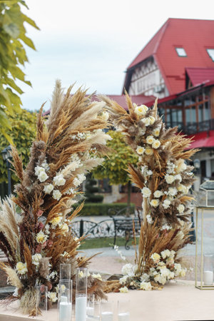 Wedding event. Decor of the wedding ceremony area with fresh flowers and pampas grassの写真素材