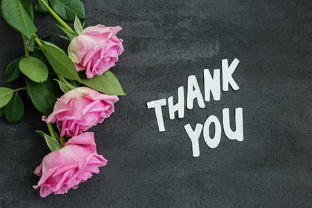 Thank you message on gray background with flowers. Background for postcard.の写真素材