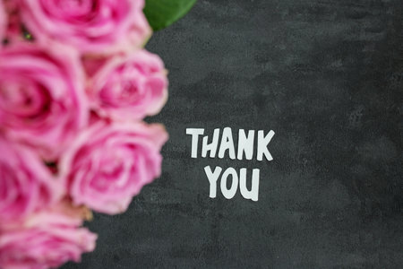 Thank you message on gray background with flowers. Background for postcard.