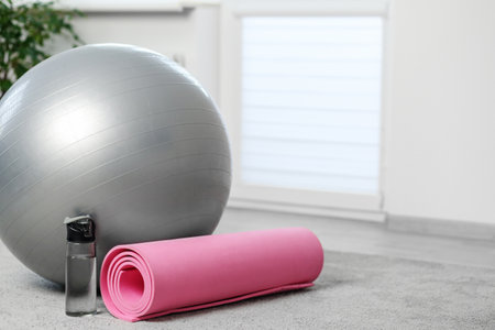 Home workout setup with yoga mat and fitness ball. Copy spaceの写真素材