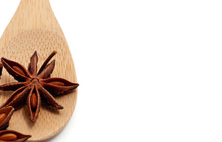 Wooden spoon with star anise on a white background top viewの写真素材
