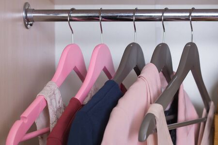 Closet hangs a proprietary on pink and gray hangerの写真素材