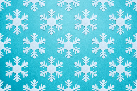 New Year and Christmas background. White snowflakes with shadows on a blue background. Pattern.
