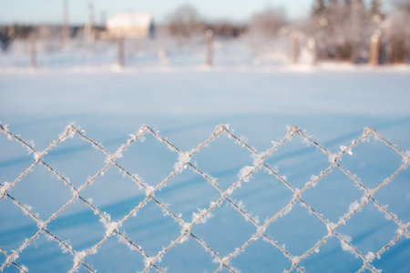 The fence is covered with frost. Textural effect, background.の写真素材