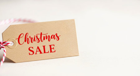 Christmas SALE tag on white background for holiday shopping, seasonal discounts, and retail marketing promotions.の素材