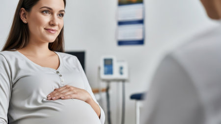 Pregnant woman at medical checkup. prenatal care concept in clinic setting.の素材
