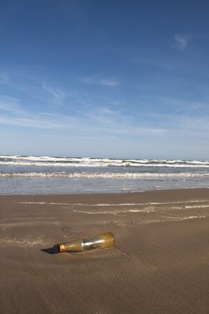 Old bottle on a beachの写真素材