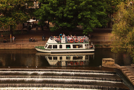 BATH, SOMERSET, UK - CIRCA 2017: Tourist boat travelling along the river in Bath on a very hot summers day.のeditorial素材
