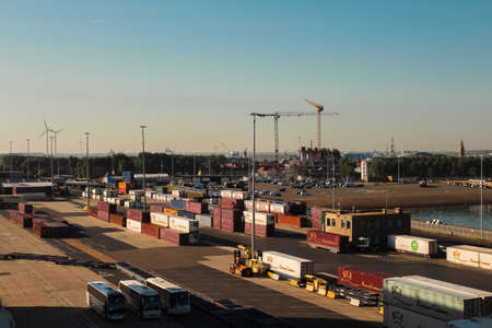 PORT OF BRUGES, BELGIUM - May 2017: Cargo, cranes, freight and containers loaded into the port at sunset.のeditorial素材