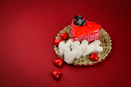 Sweet valentine s hearts on the wicker stand and red backgroundの写真素材