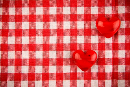 Textile texture in red and white cell with two red hearts の写真素材
