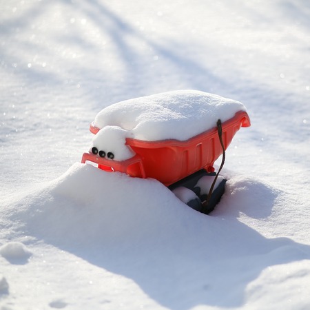 Toy car under the white snow layerの写真素材