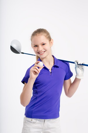 Pretty girl golfer on white backgroud in studioの写真素材