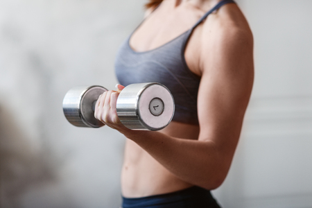 beautiful athletic woman workout with dumbellの写真素材