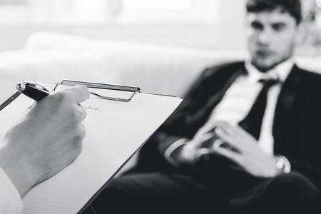 psychiatrist examining a male patientの写真素材