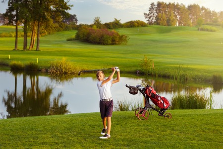 Boy playing golfの写真素材
