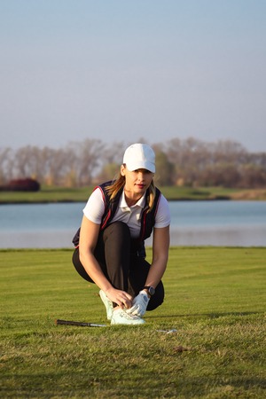 Young beautiful woman is training golf