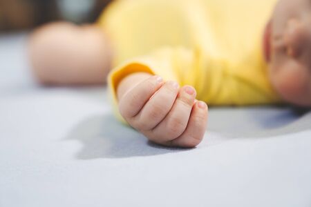 Newborn sleeping on the bed, New family and baby protection conceptの写真素材