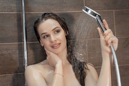 Young beautiful Caucasian woman taking shower at home