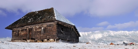 Abandoned cottage with mountains in background の写真素材
